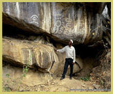 A typical rock art shelter displaying kaolin-based white symbolic art forms in the Kondoa rock art world heritage site, Tanzania (Africa)